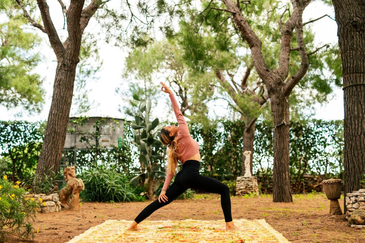 women doing yoga surrounded by trees